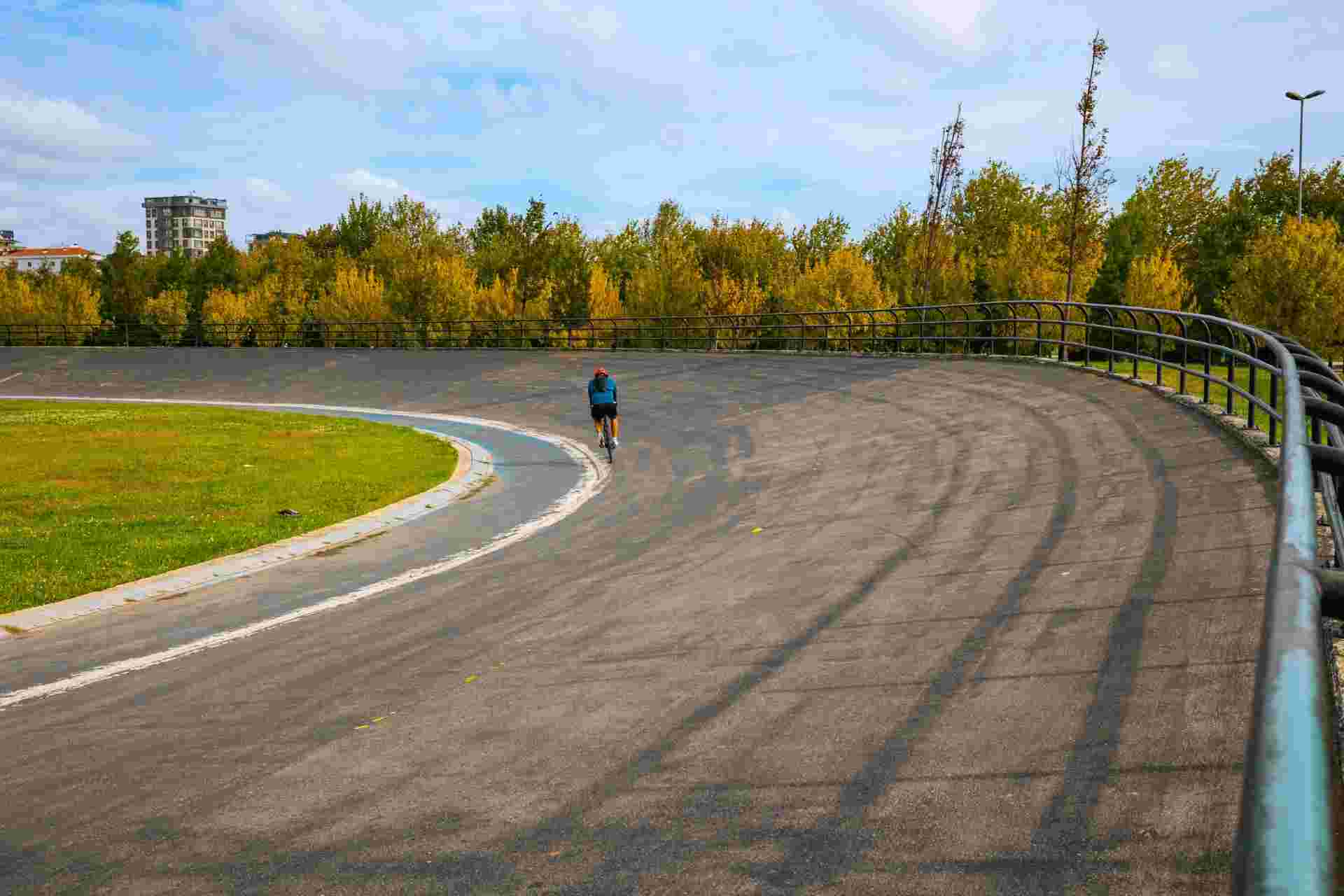 Male Cyclist in Velodrome. Cyclist training in the velodrome in the park.